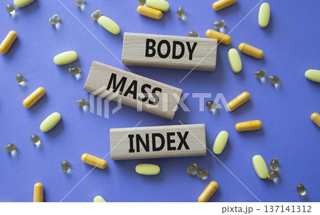 Body Mass Index symbol. Concept word Body Mass Index on wooden blocks. Beautiful purple background with pills. Medicine and Body Mass Index concept. Copy space Body Mass Index symbol. Concept word Body Mass Index on wooden blocks. Beautiful purple background with pills. Medicine and Body Mass Index concept. Copy space 137141312