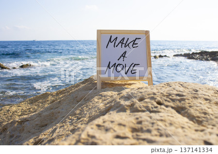 Make a Move symbol. White Blackboard with Concept words Make a Move. Beautiful sea background. Business and Make a Move concept. Copy space. Make a Move symbol. White Blackboard with Concept words Make a Move. Beautiful sea background. Business and Make a Move concept. Copy space. 137141334
