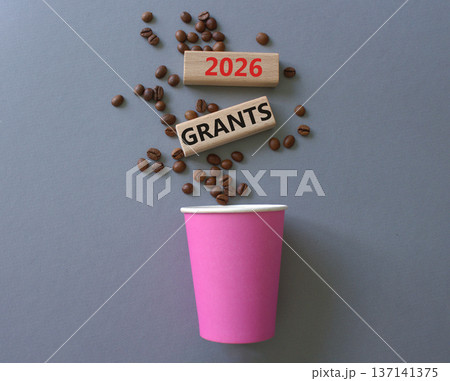 2026 Grants symbol. Concept words 2026 Grants on beautiful wooden picture frame. Beautiful grey background with coffee cup and coffee beans. Business and 2026 Grants concept. Copy space. 2026 Grants symbol. Concept words 2026 Grants on beautiful wooden picture frame. Beautiful grey background with coffee cup and coffee beans. Business and 2026 Grants concept. Copy space. 137141375