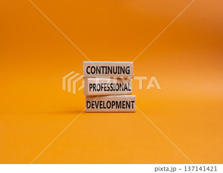 Continuing Development symbol. Concept words Continuing Professional Development on wooden blocks. Beautiful orange background. Business and Development concept. Copy space 137141421