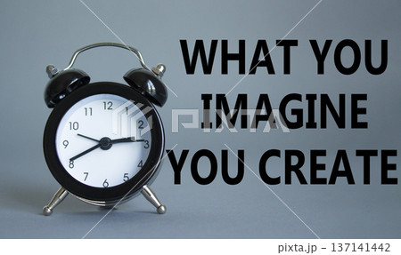 What you Imagine you Create you symbol. Wooden blocks with words What you Imagine you Create. Beautiful grey background with alarm clock. What you Imagine you Create concept. Copy space. 137141442