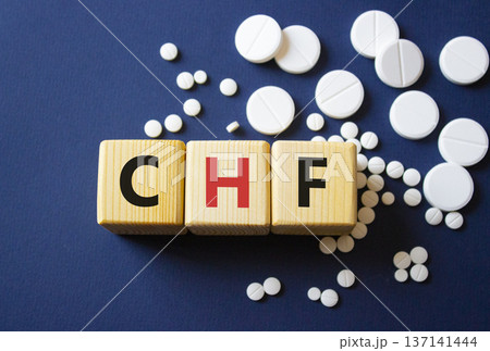 CHF symbol. Wooden cubes with words CHF Congestive Heart Failure. Beautiful deep blue background. Healthcare and Congestive Heart Failure concept. Copy space. 137141444