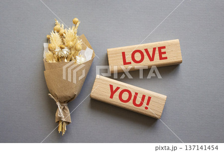 Love you symbol. Wooden blocks with words Love you. Beautiful grey background with bouquet of flowers. Healthcare and Love you concept. Copy space. Love you symbol. Wooden blocks with words Love you. Beautiful grey background with bouquet of flowers. Healthcare and Love you concept. Copy space. 137141454