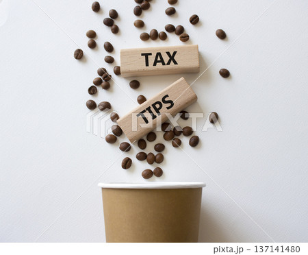 Tax Tips symbol. Wooden blocks with words Tax Tips. Beautiful white background with coffee cup and coffee beans. Business and Tax Tips concept. Copy space. 137141480