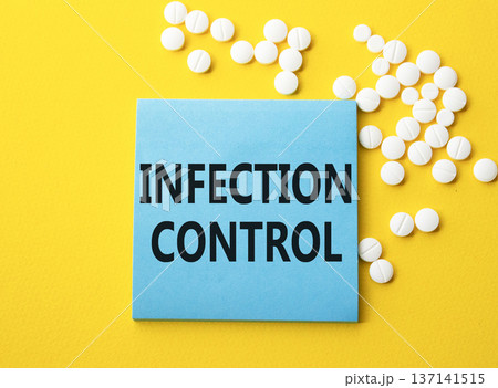 Infection Control symbol. Concept word Infection Control on blue note. Beautiful yellow background with pills. Medicine and Infection Control concept. Copy space Infection Control symbol. Concept word Infection Control on blue note. Beautiful yellow background with pills. Medicine and Infection Control concept. Copy space 137141515
