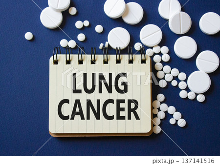 Lung Cancer symbol. Concept word Lung Cancer on notebook. Beautiful deep blue background with pills. Medicine and Lung Cancer concept. Copy space Lung Cancer symbol. Concept word Lung Cancer on notebook. Beautiful deep blue background with pills. Medicine and Lung Cancer concept. Copy space 137141516