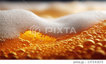 Closeup view of curved beer foam and golden bubbles on warm blurred background, expressing freshness concept 137141672