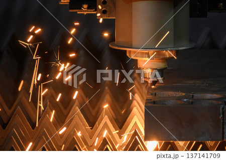 Close-up of high-power fiber laser cutting process on high-thickness steel plate, showing assist gas interaction and molten ejecta. 137141709