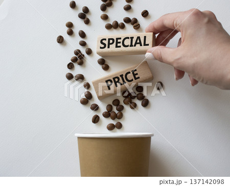 Special Price symbol. Concept word Special Price on wooden blocks. Businessman hand. Beautiful white background with coffee cup. Business and Special Price concept. Copy space 137142098