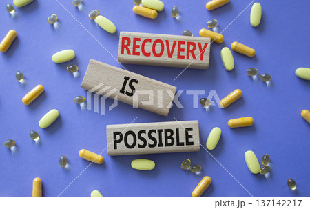 Recovery is possible symbol. Concept words Recovery is possible on wooden blocks. Beautiful purple background with pills. Healthcare and Recovery is possible concept. Copy space. Recovery is possible symbol. Concept words Recovery is possible on wooden blocks. Beautiful purple background with pills. Healthcare and Recovery is possible concept. Copy space. 137142217
