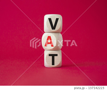 VAT - Value Added Tax symbol. Wooden cubes with word VAT. Beautiful red background. Business and Value Added Tax concept. Copy space. VAT - Value Added Tax symbol. Wooden cubes with word VAT. Beautiful red background. Business and Value Added Tax concept. Copy space. 137142223