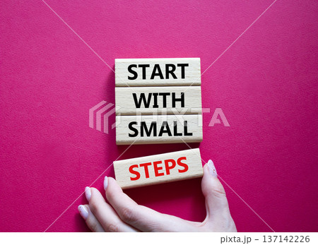 Steps symbol. Concept words Start with Small Steps on wooden blocks. Beautiful bright red background. Businessman hand. Business and Start with Small Steps concept. Copy space. 137142226
