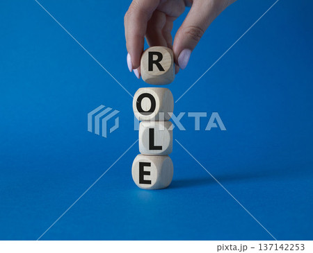 Role symbol. Concept word Role on wooden cubes. Businessman hand. Beautiful blue background. Business and Role concept. Copy space. Role symbol. Concept word Role on wooden cubes. Businessman hand. Beautiful blue background. Business and Role concept. Copy space. 137142253
