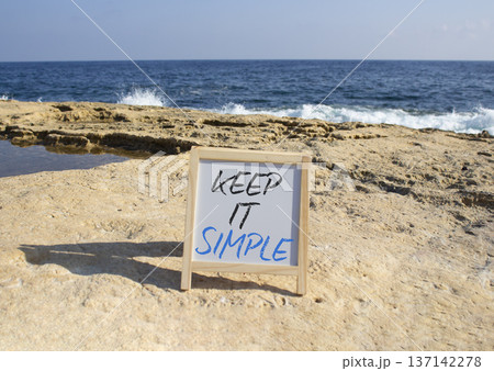 Keep it Simple symbol. Concept words Keep it Simple on chalk white blackboard. Beautiful sea background. Business and Keep it Simple concept. Copy space. Keep it Simple symbol. Concept words Keep it Simple on chalk white blackboard. Beautiful sea background. Business and Keep it Simple concept. Copy space. 137142278