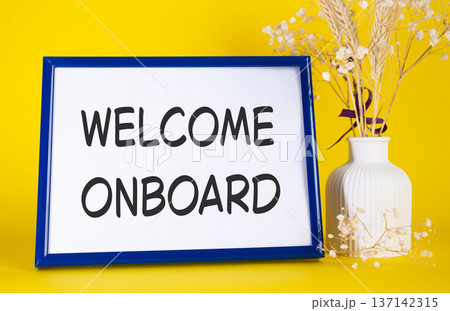 Welcome onboard symbol. Concept words Welcome onboard on beautiful wooden picture frame. Beautiful yellow background with flower vase. Business and Welcome onboard concept. Copy space. Welcome onboard symbol. Concept words Welcome onboard on beautiful wooden picture frame. Beautiful yellow background with flower vase. Business and Welcome onboard concept. Copy space. 137142315