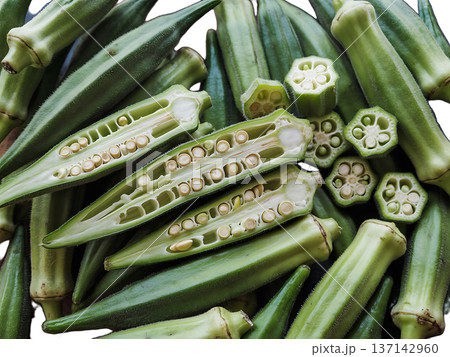 Fresh okra pods sliced open showing inner seeds and natural texture. 137142960