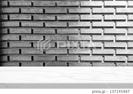 White marble countertop against a dark brick wall. White marble countertop against a dark brick wall. 137145987