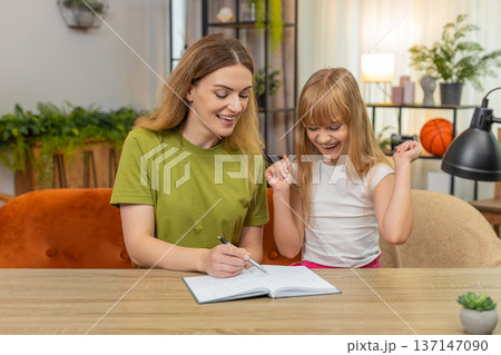 Mother daughter tic tac toe duel moves tally score notebook laugh rematch at table friendly fun play Mother daughter tic tac toe duel moves tally score notebook laugh rematch at table friendly fun play 137147090