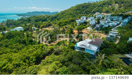 Aerial drone view of tropical hillside villas surrounded by jungle on Koh Samui island Thailand Aerial drone view of tropical hillside villas surrounded by jungle on Koh Samui island Thailand 137149699