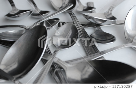Mix Of Silvery Variety Size Spoons Closeup Angle View. Cutlery Spoons Set Concept Background 137150287