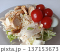 Fresh chicken caesar salad with crisp lettuce, grilled chicken breast slices, cherry tomatoes, crunchy croutons, and grated parmesan cheese, a nutritious meal option 137153673
