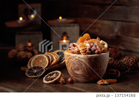 Dried fruits and assorted nuts on a wooden table. Dried fruits and assorted nuts on a wooden table. 137154168