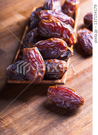 Ripe dates on an old wooden table. Ripe dates on an old wooden table. 137154179