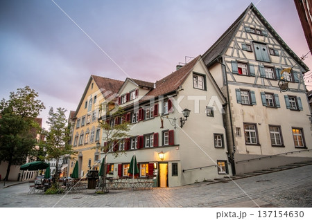 Wangen stadtmitte, germany, august 17, 2023. Meersburg, germany, showing a charming street scene with traditional half-timbered houses and inviting outdoor cafes during twilight Wangen stadtmitte, germany, august 17, 2023. Meersburg, germany, showing a charming street scene with traditional half-timbered houses and inviting outdoor cafes during twilight 137154630