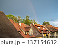 Wangen stadtmitte, germany, august 17, 2023. Rainbow arching over residential buildings with red tiled roofs, trees, and expressive sky after rain in a peaceful european town 137154632