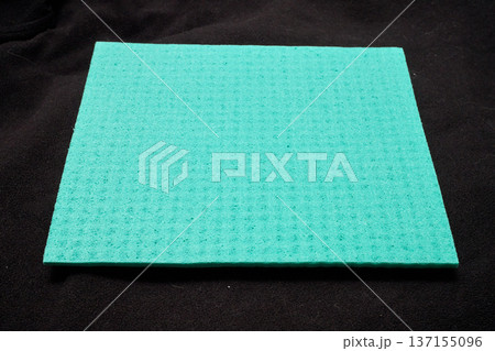 A green micro-fiber sponge on a black background A green micro-fiber sponge on a black background 137155096