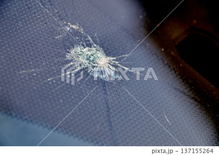 crack and impact on windshield 137155264