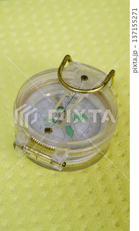 little scout plastic compass isolated on yellow background 137155271