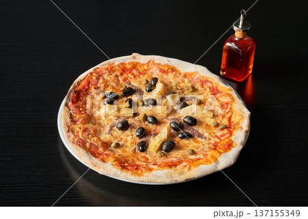 A plate of pizza with olives, capers and artichoke hearts 137155349