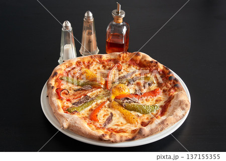 plate of Pizza with red, green and yellow peppers 137155355