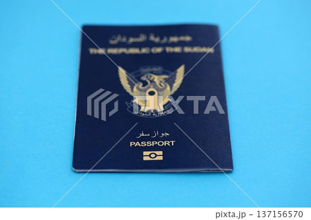 Sudanese passport on table close up. Official identification document book for citizens of Sudan. Concept of travel and tourism Sudanese passport on table close up. Official identification document book for citizens of Sudan. Concept of travel and tourism 137156570