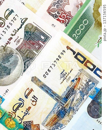 Algerian dinar paper banknotes pile on table. Algeria DZD currency money bills in big amount. Concept of economics, taxation and banking in Algeria 137156595