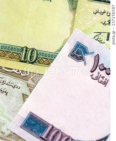 Afghan afghani paper banknotes pile on table. Afghanistan AFN currency money bills in big amount. Concept of economics, taxation and banking in Afghanistan 137156597