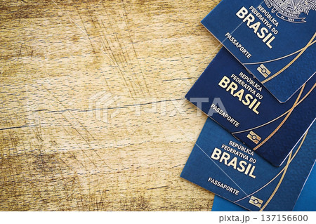Brazilian passports on table close up. Three official identification document books for citizens of Brazil. Concept of travel and tourism 137156600