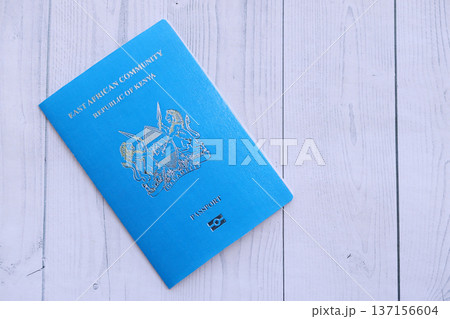 Kenyan passport on table close up. Official identification document book for citizens of Kenya. Concept of travel and tourism 137156604