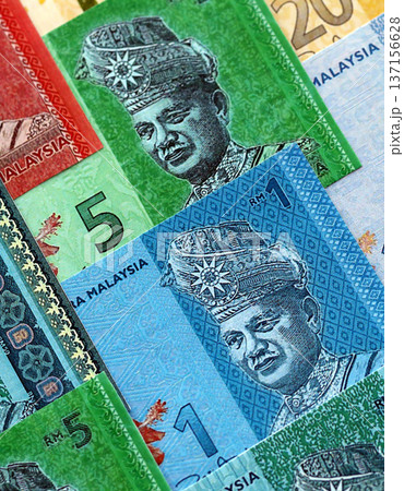 Malaysian ringgit paper banknotes pile on table. Malaysia MYR currency money bills in big amount. Concept of economics, taxation and banking in Malaysia Malaysian ringgit paper banknotes pile on table. Malaysia MYR currency money bills in big amount. Concept of economics, taxation and banking in Malaysia 137156628