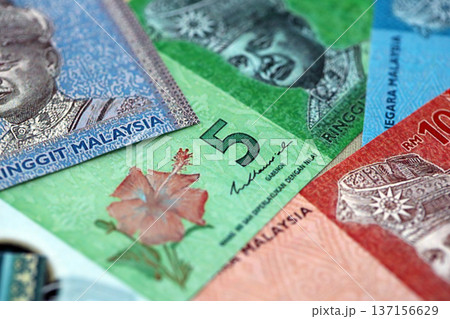 Malaysian ringgit paper banknotes pile on table. Malaysia MYR currency money bills in big amount. Concept of economics, taxation and banking in Malaysia Malaysian ringgit paper banknotes pile on table. Malaysia MYR currency money bills in big amount. Concept of economics, taxation and banking in Malaysia 137156629