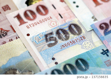 Taiwanese dollar paper banknotes pile on table. Taiwan TWD currency money bills in big amount. Concept of economics, taxation and banking in Taiwan Taiwanese dollar paper banknotes pile on table. Taiwan TWD currency money bills in big amount. Concept of economics, taxation and banking in Taiwan 137156635