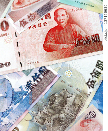 Taiwanese dollar paper banknotes pile on table. Taiwan TWD currency money bills in big amount. Concept of economics, taxation and banking in Taiwan Taiwanese dollar paper banknotes pile on table. Taiwan TWD currency money bills in big amount. Concept of economics, taxation and banking in Taiwan 137156639