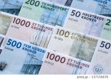 Danish krone paper banknotes pile on table. Denmark DKK currency money bills in big amount. Concept of economics, taxation and banking in Denmark Danish krone paper banknotes pile on table. Denmark DKK currency money bills in big amount. Concept of economics, taxation and banking in Denmark 137156676