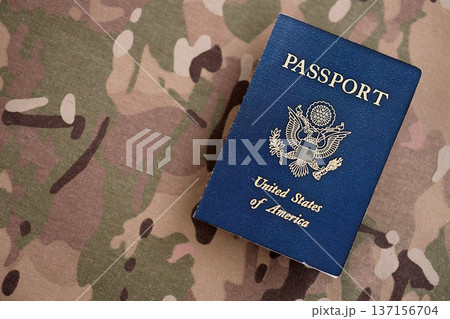 US passport on table close up. Official identification document book for citizens of United States. Concept of travel and tourism US passport on table close up. Official identification document book for citizens of United States. Concept of travel and tourism 137156704