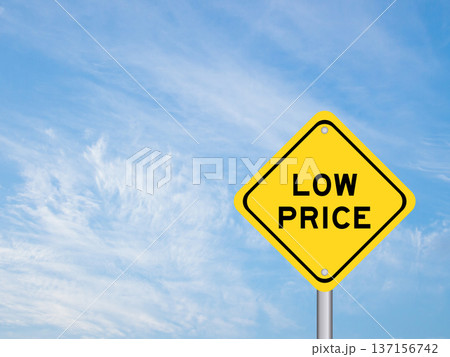 Yellow transportation sign with word low price on blue color sky background Yellow transportation sign with word low price on blue color sky background 137156742