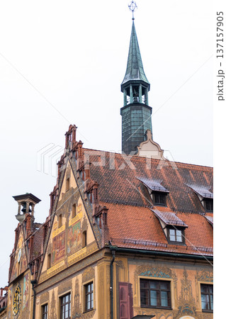 Historic Ulm Rathaus building in Germany features intricate frescoes and a tall spire. The architecture showcases traditional German design elements. 137157905