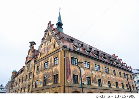 Historic Ulm Rathaus building in Germany features intricate frescoes and a tall spire. The architecture showcases traditional German design elements. 137157906
