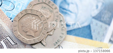 Coins and banknotes of United Kingdom and Great Britain pound currency. UK money close up. Business, economy and finance concept Coins and banknotes of United Kingdom and Great Britain pound currency. UK money close up. Business, economy and finance concept 137158066