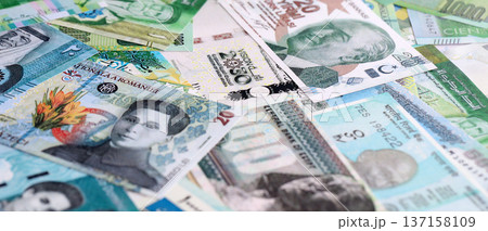 Various currencies money bills banknotes in green color. Many cash bills from different countries in big pile close up. World economy and currency exchange concept Various currencies money bills banknotes in green color. Many cash bills from different countries in big pile close up. World economy and currency exchange concept 137158109